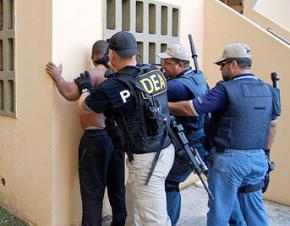 Drug Enforcement Administration agents arrest a suspect
