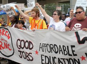 Occupy protesters march outside the first day of the Republican National Convention